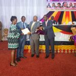 Kosiya receiving an award from Hon Ruhakana Rugunda