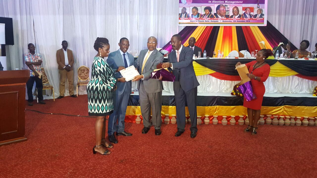 Kosiya receiving an award from Hon Ruhakana Rugunda